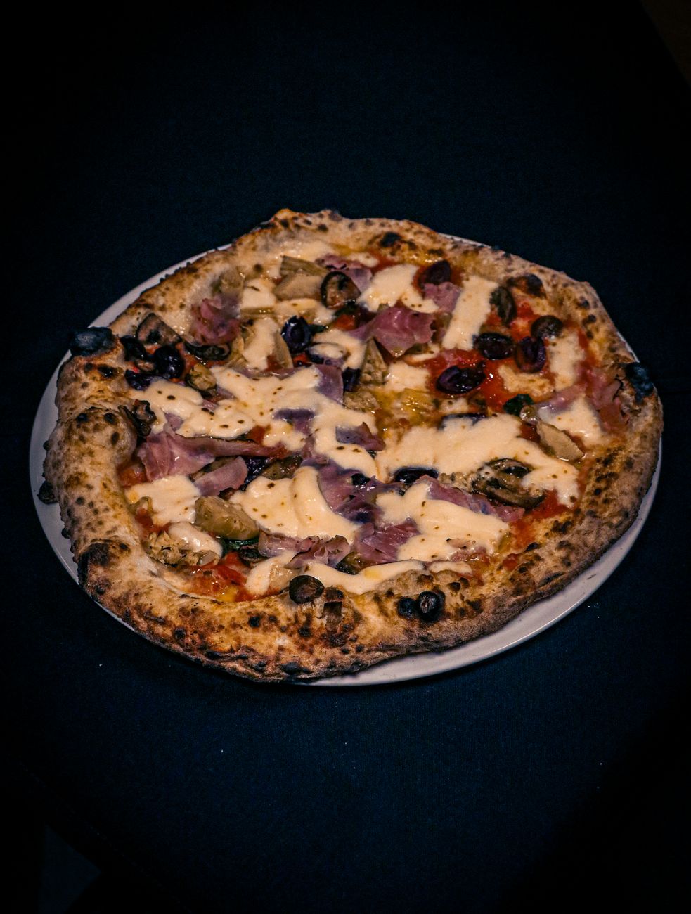 Pizza with cured meat